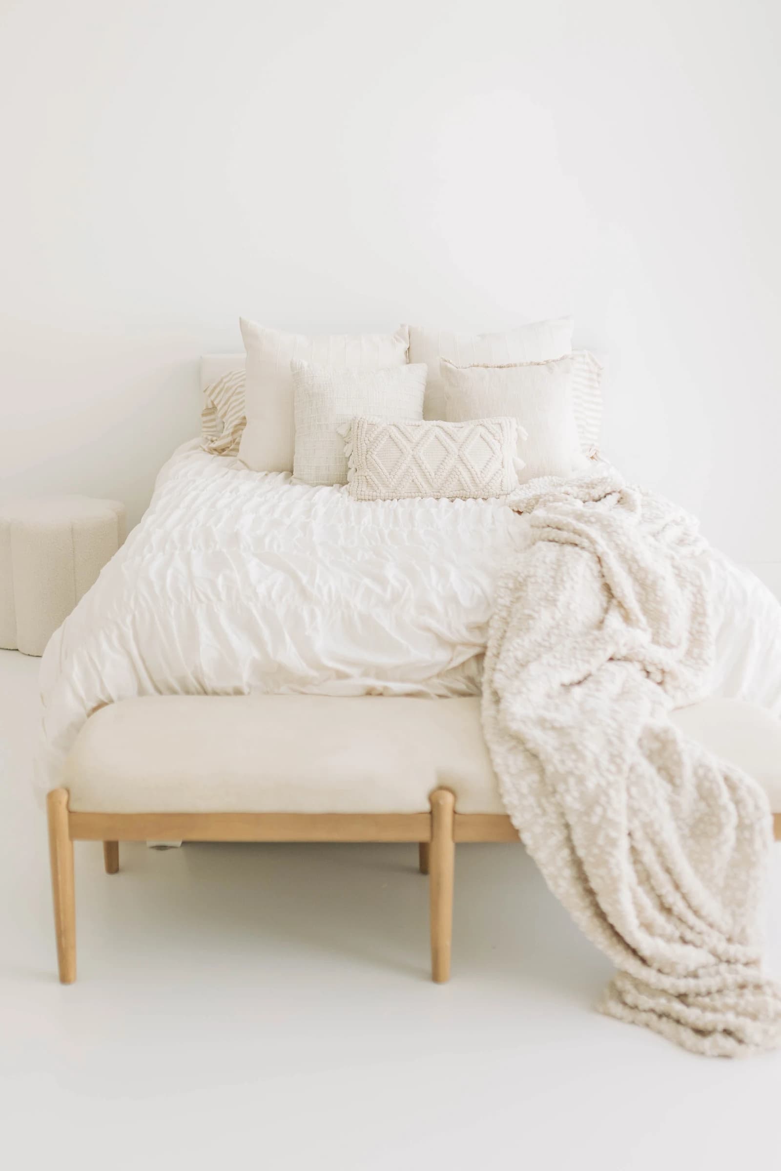A chunky knit throw over Studio A's bed